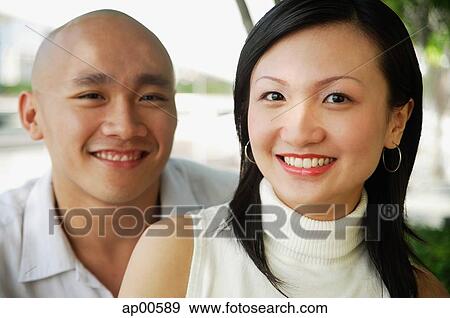 Stock Photo - Couple looking at camera. Fotosearch