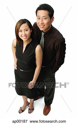 Couple standing, looking at camera, smiling View Large Photo Image Stock Photo - Couple standing, looking at camera, smiling. Fotosearch