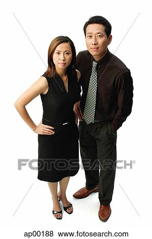 Couple standing, looking at camera, woman with hand on hip View Large Photo Image Stock Photo - Couple standing, looking at camera, woman with hand on hip. Fotosearch