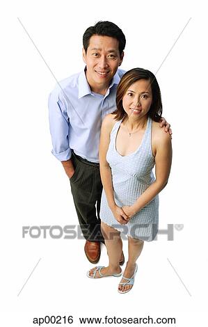 Couple standing, smiling at camera View Large Photo Image Stock Photograph - Couple standing, smiling at camera. Fotosearch