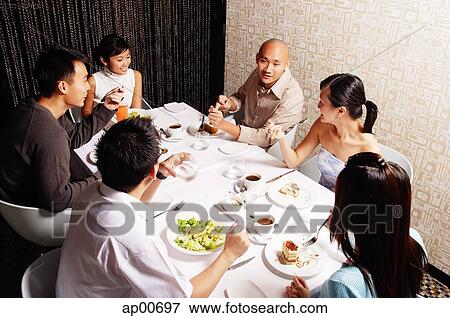 Couples eating at restaurant View Large Photo Image Stock Photo - Couples eating at restaurant. Fotosearch