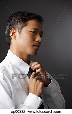 Executive adjusting tie View Large Photo Image Stock Image - Executive adjusting tie. Fotosearch
