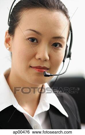 Stock Photograph - Executive with headset, looking at camera. Fotosearch