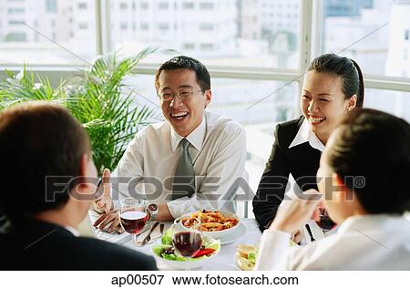 Executives at restaurant, having lunch View Large Photo Image Stock Photo - Executives at restaurant, having lunch. Fotosearch