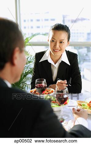 Executives discussing over lunch View Large Photo Image Stock Image - Executives discussing over lunch. Fotosearch