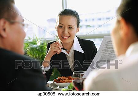 Executives having a meeting over lunch View Large Photo Image Stock Photography - Executives having a meeting over lunch. Fotosearch