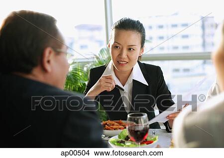 Picture - Executives having a working lunch. Fotosearch
