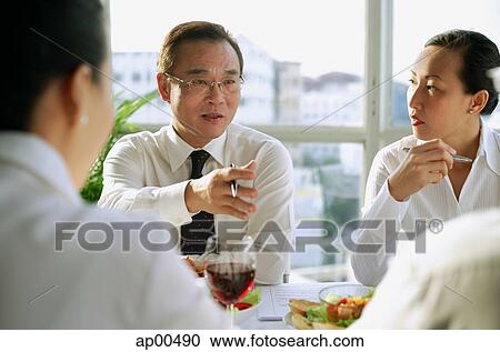 Executives having lunch meeting View Large Photo Image Stock Image - Executives having lunch meeting. Fotosearch