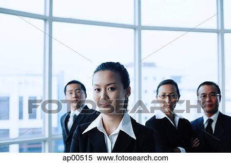 Executives standing in a row, looking at camera View Large Photo Image Stock Photography - Executives standing in a row, looking at camera. Fotosearch