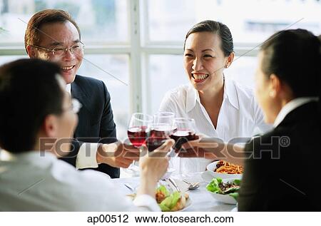 Stock Image - Executives toasting with wine. Fotosearch