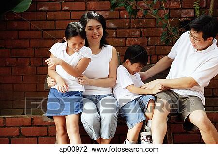 Stock Image - Family with two children, fooling around. Fotosearch