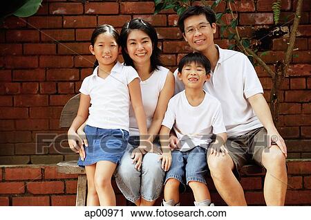 Family with two children, looking at camera, portrait View Large Photo Image Stock Image - Family with two children, looking at camera, portrait. Fotosearch