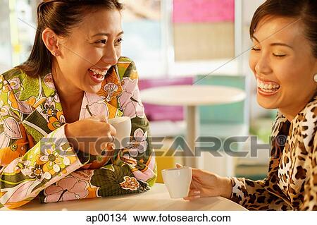 Picture - Friends having tea at cafe, laughing. Fotosearch