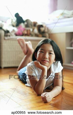 Girl in bedroom, lying on floor, hand on chin View Large Photo Image Stock Photography - Girl in bedroom, lying on floor, hand on chin. Fotosearch