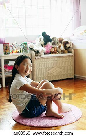 Girl in bedroom, sitting on floor, hugging knees View Large Photo Image Stock Image - Girl in bedroom, sitting on floor, hugging knees. Fotosearch