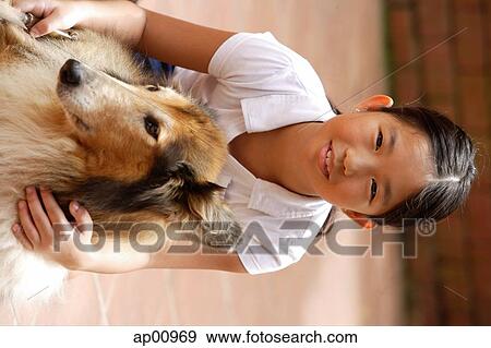 Girl with dog, looking at camera View Large Photo Image Stock Photo - Girl with dog, looking at camera. Fotosearch