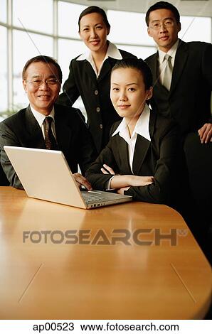 Stock Image - Group of executives, in boardroom, portrait. Fotosearch