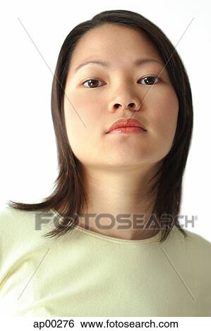 Stock Photograph - Head shot, young woman looking at camera. Fotosearch