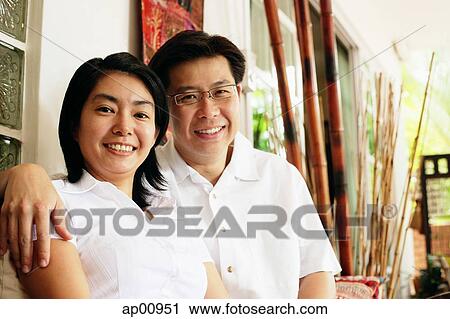 Husband and wife looking at camera, portrait View Large Photo Image Stock Image - Husband and wife looking at camera, portrait. Fotosearch