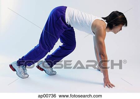 Man bending at starting position, side view View Large Photo Image Stock Photograph - Man bending at starting position, side view. Fotosearch