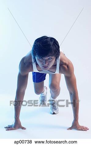 Man bending at starting position, looking at camera View Large Photo Image Stock Photo - Man bending at starting position, looking at camera. Fotosearch