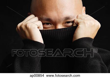 Man hiding behind turtleneck View Large Photo Image Picture - Man hiding behind turtleneck. Fotosearch