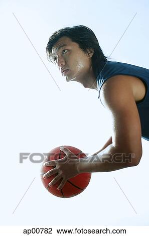 Man holding basketball, looking up View Large Photo Image Stock Image - Man holding basketball, looking up. Fotosearch