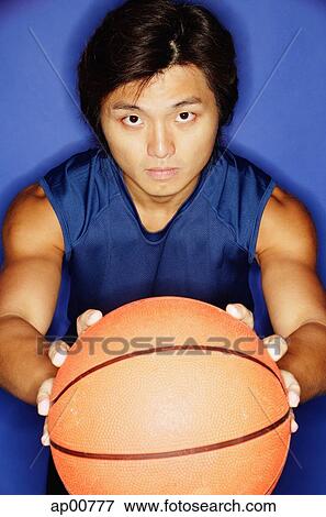 Man holding basketball out towards camera View Large Photo Image Stock Photo - Man holding basketball out towards camera. Fotosearch