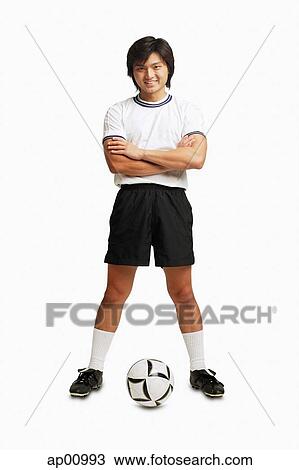 Man in soccer uniform, arms crossed, standing with soccer ball View Large Photo Image Stock Image - Man in soccer uniform, arms crossed, standing with soccer ball. Fotosearch