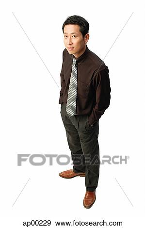 Man in studio, looking up at camera View Large Photo Image Stock Photo - Man in studio, looking up at camera. Fotosearch