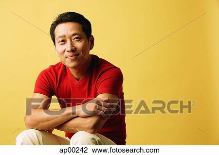 Man looking at camera, arms crossed View Large Photo Image Stock Image - Man looking at camera, arms crossed. Fotosearch