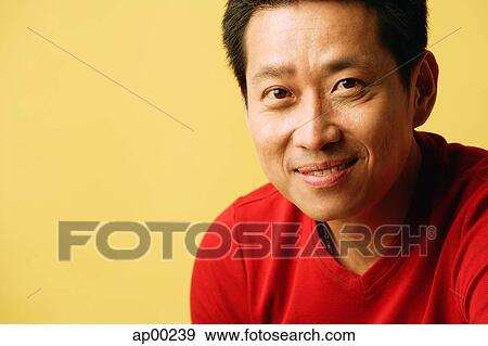 Stock Photo - Man looking at camera, smiling. Fotosearch