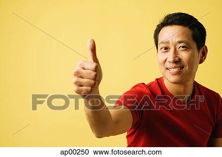 Stock Image - Man making thumbs up sign. Fotosearch