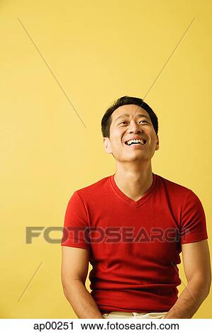 Stock Image - Man smiling, looking up. Fotosearch