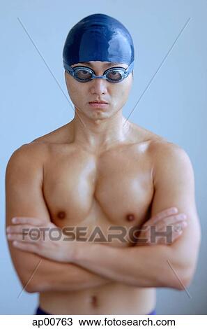 Man wearing swimming cap and goggles, arms crossed, looking at camera View Large Photo Image Stock Image - Man wearing swimming cap and goggles, arms crossed, looking at camera. Fotosearch