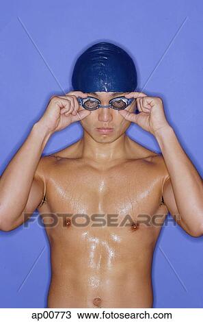 Man wearing swimming cap and goggles, adjusting goggles View Large Photo Image Stock Image - Man wearing swimming cap and goggles, adjusting goggles. Fotosearch
