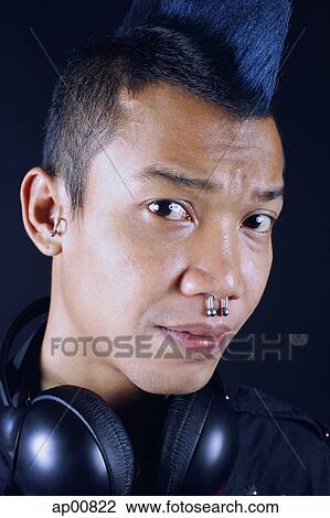Man with mohawk, headphones around neck, looking at camera View Large Photo Image Stock Image - Man with mohawk, headphones around neck, looking at camera. Fotosearch