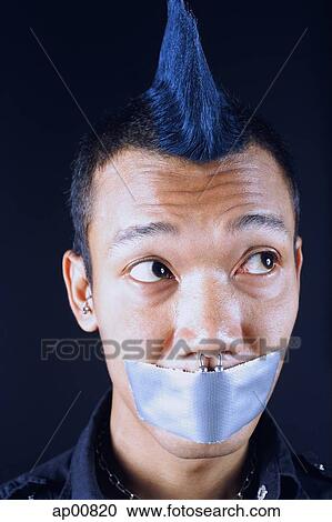 Man with mohawk, mouth taped shut, looking away View Large Photo Image Stock Image - Man with mohawk, mouth taped shut, looking away. Fotosearch