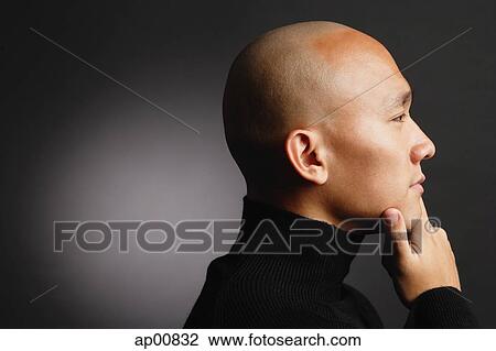 Man with shaved head, hand on chin, profile View Large Photo Image Stock Image - Man with shaved head, hand on chin, profile. Fotosearch