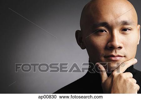 Man with shaved head, looking at camera, hand on chin View Large Photo Image Stock Image - Man with shaved head, looking at camera, hand on chin. Fotosearch