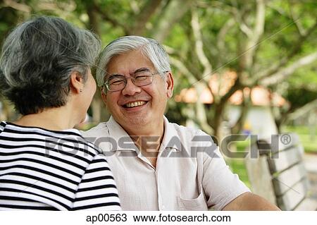 Mature couple facing each other, man smiling View Large Photo Image Stock Image - Mature couple facing each other, man smiling. Fotosearch
