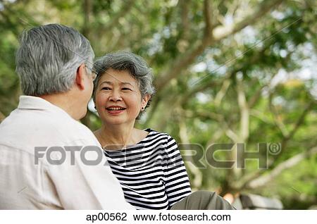 Mature couple facing each other, woman smiling View Large Photo Image Stock Image - Mature couple facing each other, woman smiling. Fotosearch