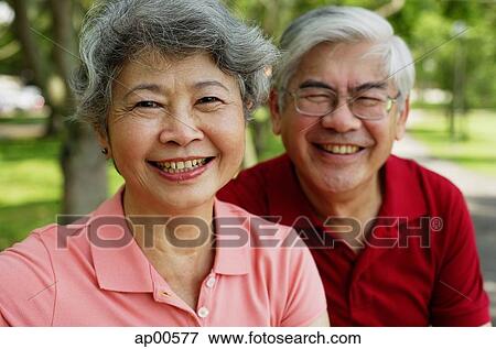 Stock Photo - Mature couple, looking at camera, smiling. Fotosearch