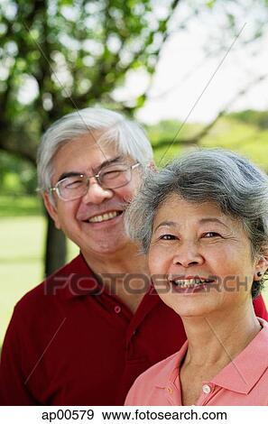 Stock Photo - Mature couple, looking at camera, portrait. Fotosearch