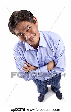 Stock Photography - Mature man looking at camera, arms crossed. Fotosearch