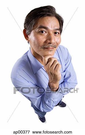 Mature man looking at camera, hand on chin View Large Photo Image Stock Photo - Mature man looking at camera, hand on chin. Fotosearch