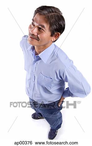 Stock Photograph - Mature man looking away, hands on hips. Fotosearch