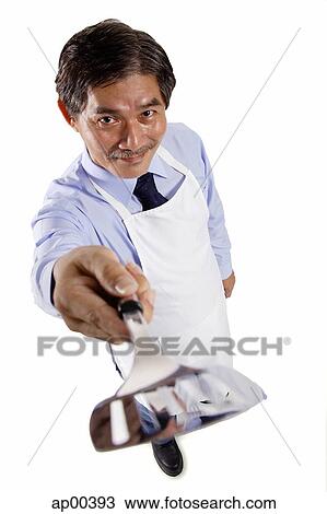Mature man wearing apron, pointing spatula at camera View Large Photo Image Stock Image - Mature man wearing apron, pointing spatula at camera. Fotosearch