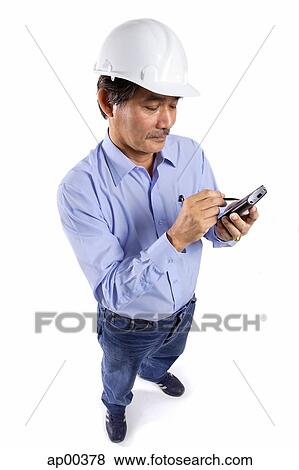 Mature man wearing construction hat, using PDA View Large Photo Image Stock Photo - Mature man wearing construction hat, using PDA. Fotosearch