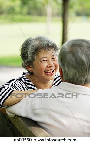 Mature woman sitting, smiling, facing man View Large Photo Image Stock Image - Mature woman sitting, smiling, facing man. Fotosearch